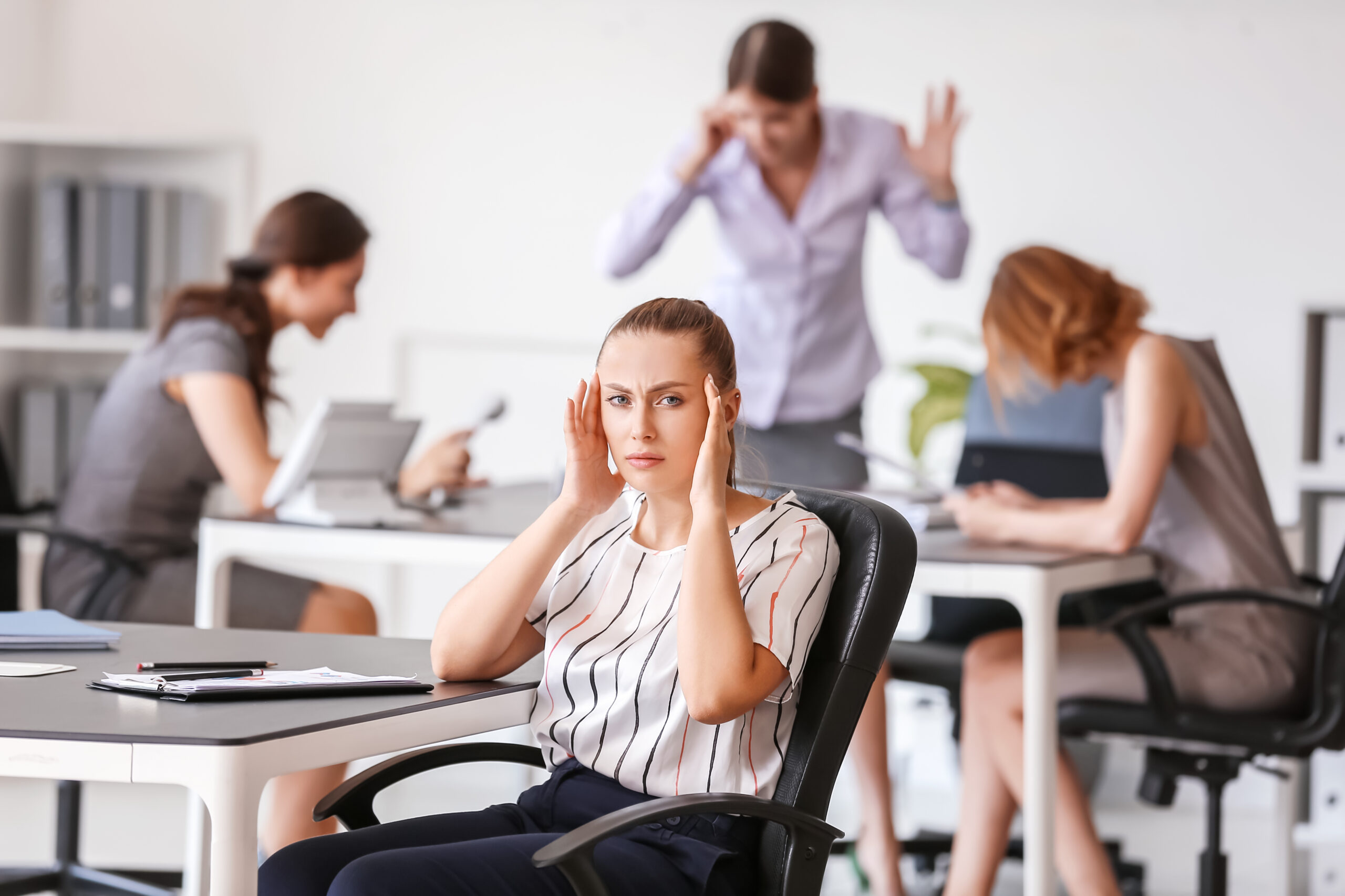 Stressed,Woman,With,Headache,And,Noisy,People,In,Office